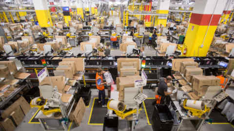 Workers prepare orders for shipment at the Amazon.com Inc. fulfillment center in Passo Corese, Rieti, Italy, on Thursday, July 26, 2018. Amazon reported a record second-quarter profit of $2.53 billion, or $5.07 per share. Photographer: Giulio Napolitano/Bloomberg
