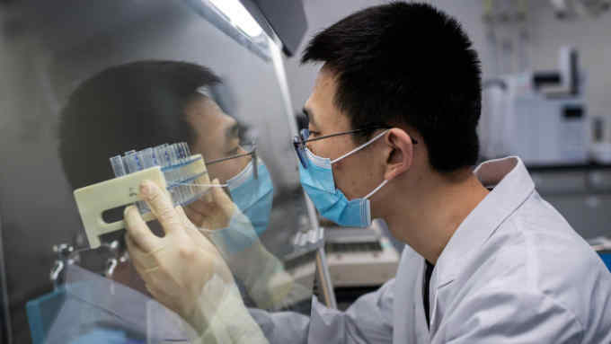 TOPSHOT - In this picture taken on April 29, 2020, an engineer works at the Quality Control Laboratory on an experimental vaccine for the COVID-19 coronavirus at the Sinovac Biotech facilities in Beijing. - Sinovac Biotech, which is conducting one of the four clinical trials that have been authorised in China, has claimed great progress in its research and promising results among monkeys. (Photo by NICOLAS ASFOURI / AFP) / TO GO WITH Health-virus-China-vaccine,FOCUS by Patrick Baert (Photo by NICOLAS ASFOURI/AFP via Getty Images)