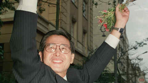 LIMA, PERU - JUNE 10: Alberto Kenyo Fujimori, presidential candidate for the &quot;Cambio90&quot; party, salutes 10 June 1990 in Lima, a crowd of supporters upon his arrival at a press conference. Though vote is not official yet, Fujimori holds a commanding lead over his opponent writer Mario Vargas Llosa of Democratic Front. (Photo credit should read MARCO UGARTE/AFP/Getty Images)