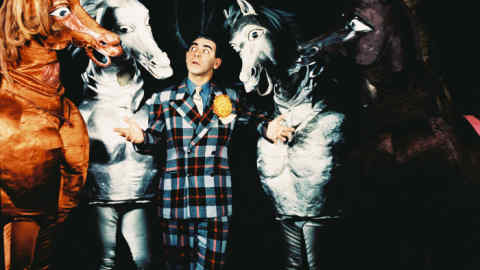 Eddie Cantor (1892-1964), US actor and comedian, wearing a plaid suit as he poses with four pantomime horses, against a black background, circa 1935. (Photo by Silver Screen Collection/Getty Images)