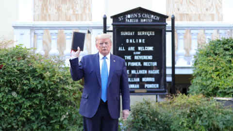 U.S. President Donald Trump holds up a Bible as he stands in front of St. John's Episcopal Church across from the White House after walking there for a photo opportunity during ongoing protests over racial inequality in the wake of the death of George Floyd while in Minneapolis police custody, at the White House in Washington, U.S., June 1, 2020. REUTERS/Tom Brenner TPX IMAGES OF THE DAY
