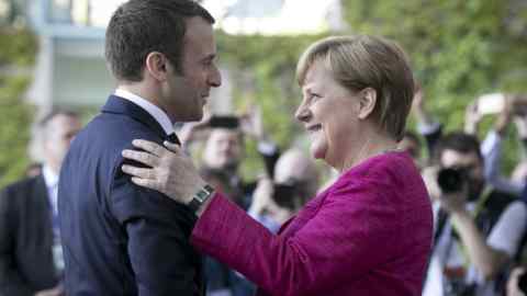 BERLIN, GERMANY - MAY 15: German Chancellor Angela Merkel and newly-elected French President Emmanuel Macron chat upon Macron's arrival at the Chancellery on May 15, 2017 in Berlin, Germany. Macron is visiting Berlin only a day after being sworn in as president in Paris. While Macron and Merkel have both demonstrated an unwavering commitment to the European Union and Merkel strongly applauded Macron's election, they are likely to differ over Macron's desire for E.U.-issued bonds, a measure Merkel has strongly opposed in the past. (Photo by Axel Schmidt/Getty Images)