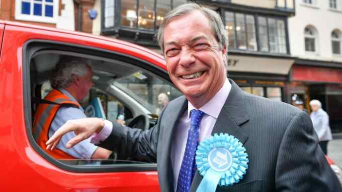 Brexit Party leader Nigel Farage laughs as he meets a Royal Mail driver during the campaign trail in Exeter, ahead of this week's European elections. PRESS ASSOCIATION Photo. Picture date: Monday May 20, 2019. See PA story POLITICS Election. Photo credit should read: Ben Birchall/PA Wire