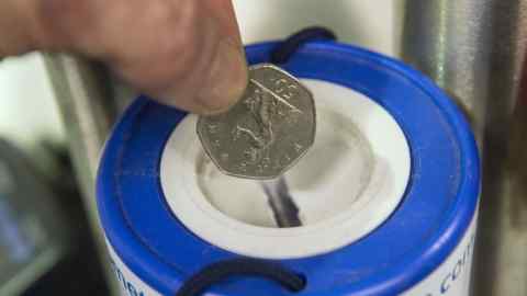 Embargoed to 0001 Thursday October 26 PICTURE POSED BY PHOTOGRAPHER File photo dated 01/02/16 of a coin being dropped into a charity collection container, as fresh advice has been issued to help foil fraudsters who target kind-hearted people who donate to charity.