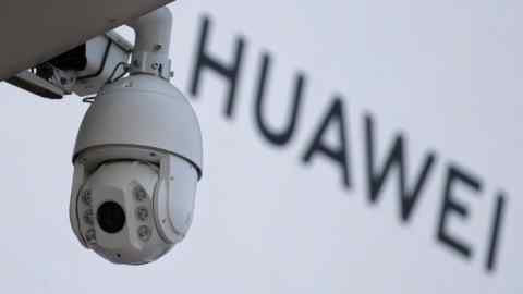 A surveillance camera is seen next to a sign of Huawei outside a shopping mall in Beijing, China January 29, 2019. REUTERS/Jason Lee