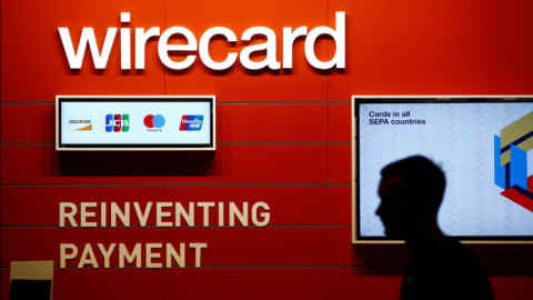 FILE PHOTO: A man walks past the Wirecard booth at the computer games fair Gamescom in Cologne, Germany, August 22, 2018. REUTERS/Wolfgang Rattay/File Photo