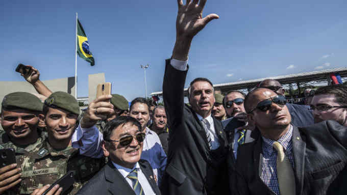 Brazilian congressman and presidential canditate for the next election, Jair Bolsonaro, waves to the crowd during a military event in Sao Paulo, Brazil on May 3, 2018. (Photo by Nelson ALMEIDA / AFP) (Photo credit should read NELSON ALMEIDA/AFP/Getty Images)