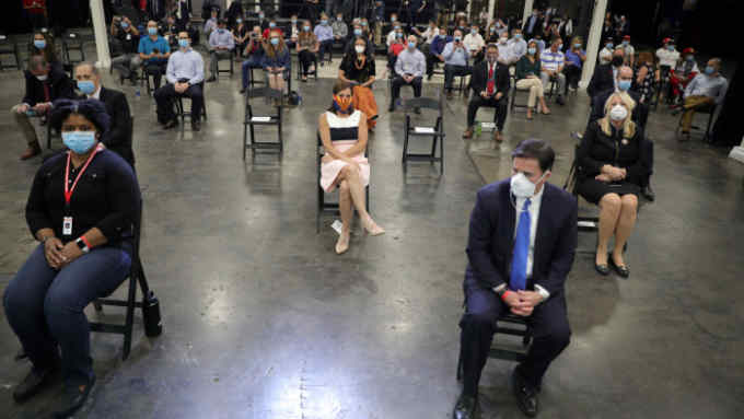 Honeywell manufacturing workers seated based on pandemic social distancing guidelines wait to listen to U.S. President Donald Trump as he visits their facility manufacturing protective face masks for the coronavirus disease (COVID-19) outbreak in Phoenix, Arizona, U.S., May 5, 2020. REUTERS/Tom Brenner TPX IMAGES OF THE DAY