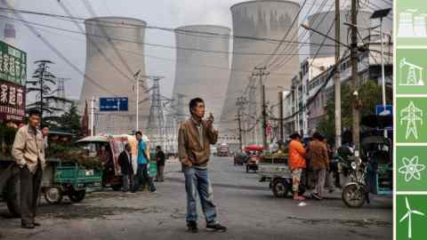 HUAINAN, CHINA - JUNE 14: Chinese street vendors and customers gather at a local market outside a state owned Coal fired power plant near the site of a large floating solar farm project under construction by the Sungrow Power Supply Company on a lake caused by a collapsed and flooded coal mine on June 14, 2017 in Huainan, Anhui province, China. The floating solar field, billed as the largest in the world, is built on a part of the collapsed Panji No.1 coal mine that flooded over a decade ago due to over-mining, a common occurence in deep-well mining in China's coal heartland. When finished, the solar farm will be made up of more than 166,000 solar panels which convert sunlight to energy, and the site could potentially produce enough energy to power a city in Anhui province, regarded as one of the country's coal centers. Local officials say they are planning more projects like it, marking a significant shift in an area where long-term intensive coal mining has led to large areas of subsidence and environmental degradation. However, the energy transition has its challenges, primarily competitive pressure from the deeply-established coal industry that has at times led to delays in connecting solar projects to the state grid. Chinaâs government says it will spend over US $360 billion on clean energy projects by 2020 to help shift the country away from a dependence on fossil fuels, and earlier this year, Beijing canceled plans to build more than 100 coal-fired plants in a bid to ease overcapacity and limit carbon emissions. Already, China is the leading producer of solar energy, but it also remains the planetâs top emitter of greenhouse gases and accounts for about half of the worldâs total coal consumption. (Photo by Kevin Frayer/Getty Images)