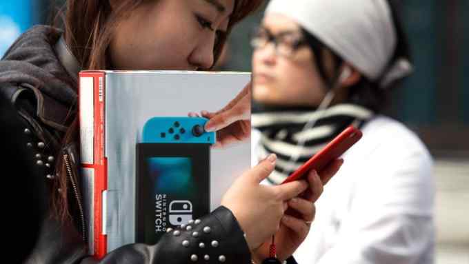 TOKYO, JAPAN - MARCH 03 : Japanese gamers come to buy the new video game Nintendo Switch games console by Nintendo Co. during the first day of sales worldwide in Tokyo, Japan on March 03, 2017. This next-generation game console, billed as a combination of a home device experience and a portable entertainment system, is available for sale at $ 299.99. (Photo by Richard Atrero de Guzman/Anadolu Agency/Getty Images)
