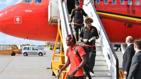 Belgium's defender Dedryck Boyata, Belgium's midfielder Marouane Fellaini disembark from a plane upon the team's arrival at Moscow's Sheremetyevo airport on June 13, 2018, ahead of the Russia 2018 World Cup football tournament. (Photo by Yuri KADOBNOV / AFP)        (Photo credit should read YURI KADOBNOV/AFP/Getty Images)