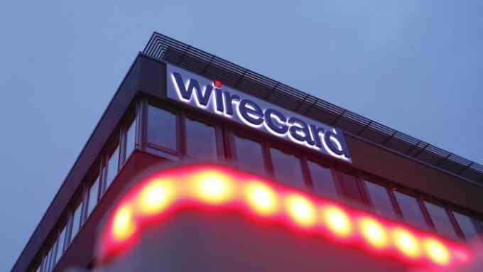 An illuminated logo sits on the exterior of the Wirecard AG headquarters in the Aschheim district of Munich, Germany, on Tuesday, Feb. 12, 2019. Wirecard broke federal securities law by failing to act on an executive’s misconduct and misleading investors about it, a complaint filed Feb. 8 in the Central District of California alleges. Photographer: Michaela Handrek-Rehle/Bloomberg