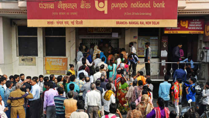 Customers wait in line to exchange Indian five hundred and one thousand rupee banknotes outside a Punjab National Bank branch in New Delhi, India, on Tuesday, Nov. 15, 2016. The Indian government is battling to keep cash dispensing machines running after efforts to ease withdrawals failed to keep pace for the fifth straight day. Photographer: Anindito Mukherjee/Bloomberg
