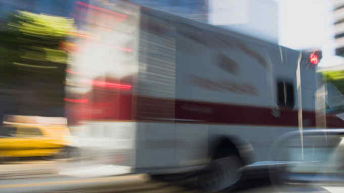 AJ6AH6 Blurred motion image of an ambulance in the Financial District San Francisco California USA