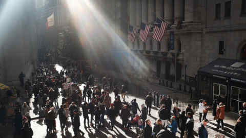 NEW YORK, NEW YORK - DECEMBER 29: People congregate outside of the New York Stock Exchange (NYSE) in lower Manhattan during the holiday week between Christmas and the New Year on December 29, 2018 in New York City. Despite the government shutdown, the Statue of Liberty and the Museum of the American Indian, two major tourists destinations, have so far remained open. (Photo by Spencer Platt/Getty Images)
