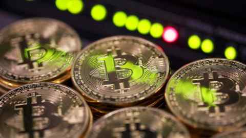 Stacks of bitcoins sit near green lights on a data cable terminal inside a communications room at an office in this arranged photograph in London, U.K., on Tuesday, Sept. 5, 2017. Bitcoin steadied after its biggest drop since June as investors and speculators reappraised the outlook for initial coin offerings. Photographer: Chris Ratcliffe/Bloomberg