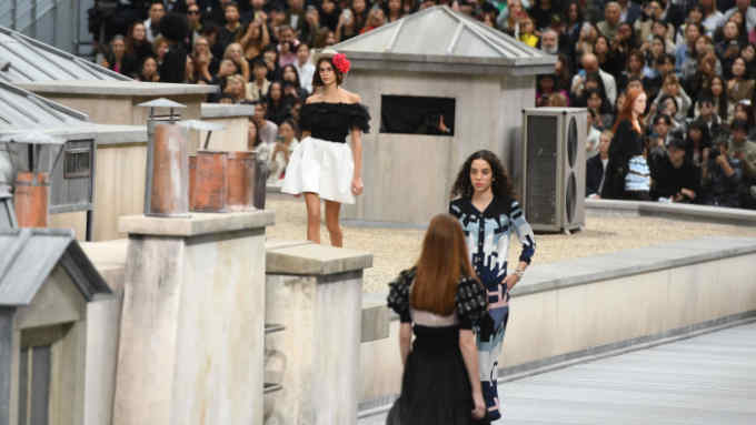 US model Kaia Gerber (back) presents a creation by Chanel during the Women's Spring-Summer 2020 Ready-to-Wear collection fashion show at the Grand Palais in Paris, on October 1, 2019. (Photo by Christophe ARCHAMBAULT / AFP)        (Photo credit should read CHRISTOPHE ARCHAMBAULT/AFP/Getty Images)