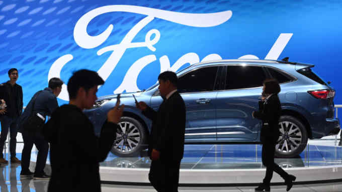 Visitor walk past a Ford Escape Titanium at the Shanghai Auto Show in Shanghai on April 17, 2019. (Photo by GREG BAKER / AFP)GREG BAKER/AFP/Getty Images