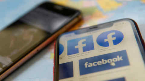 FILE PHOTO: Facebook logos are seen on a mobile phone in this picture illustration taken December 2, 2019. REUTERS/Johanna Geron/Illustration/File Photo