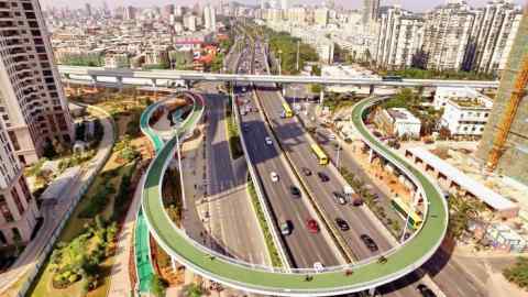 Mandatory Credit: Photo by Xinhua/Shutterstock (8326468a) New cycle route above a motorway New bicycle route built, Xiamen, Fujian Province, China - 09 Feb 2017 According to Xiamen City Public Bicycle Management, the path will be open to all kinds of bikes, including public and private bikes, from 6:30 a.m. to 10:30 p.m. during the month-long trial, in a bid to promote green transport.