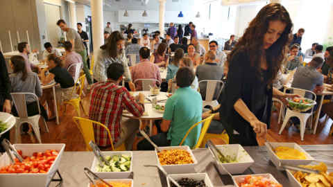 A lunchroom at Oscar Health, which offers a catered lunch for employees a few times a week, at the startup insurer's offices in New York, May 23, 2016. (Richard Perry/The New York Times)