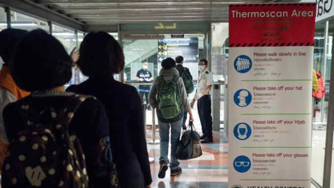 BANGKOK, THAILAND - JANUARY 08: Public Health Officials run thermal scans on passengers arriving from Wuhan, China at Suvarnabumi Airport on January 8, 2020 in Bangkok, Thailand. Thailand has ordered thermoscanning of passengers in four Thai airports, including Suvarnabumi, Don Mueang, Phuket and Chiang Mai. The disease surveillance and monitoring came about as a response to a severe pneumonia outbreak in Wuhan. (Photo by Lauren DeCicca/Getty Images)