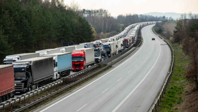 TOPSHOT - A picture taken on March 19, 2020 shows trucks stuck in a traffic jam on the A4 highway, some 40km far from Germany's border to Poland near Bautzen, eastern Germany. (Photo by JENS SCHLUETER / AFP) (Photo by JENS SCHLUETER/AFP via Getty Images)