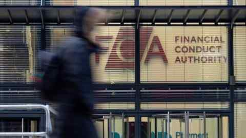 A person walks past the office of the Financial Conduct Authority