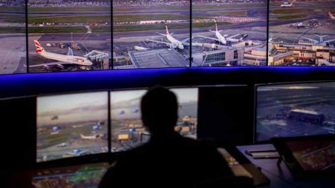 Air Traffic Control Engineers use screens displaying real-time panoramic views of the runways and docking gates, as they work on a non-operational trial in the NATS Digital Tower Laboratory, inside the control tower at London Heathrow Airport