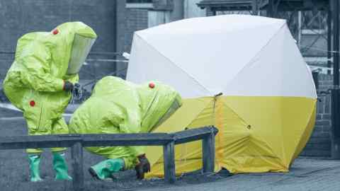 Personnel in hazmat suits working to secure a tent covering a bench in the Maltings shopping centre in Salisbury in 2018 after the attempted murder of Sergei Skripal, a former Russian spy who had defected to the UK