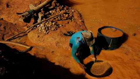 Dirty business: a garimpeiro — illegal miner — uses a basin and mercury to pan for gold on deforested land in Pará state
