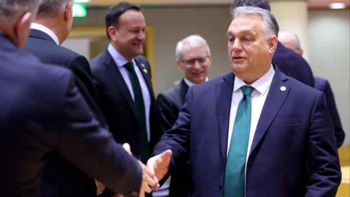 Viktor Orbán shakes hands with fellow EU leaders