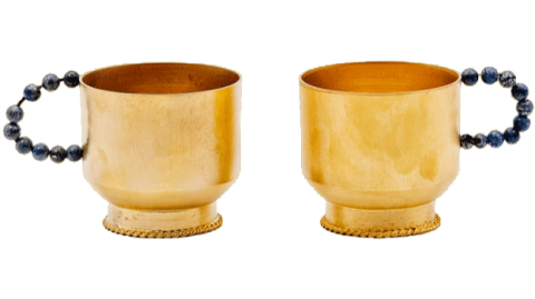 a couple of gold-plated brass drinking cups