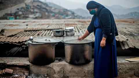 A woman at a soup kitchen in Lima, Peru. The scale of the virus crisis has dealt a huge blow to already sickly economies