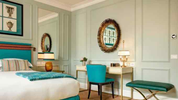 The Deluxe Suite at the Palazzo Ripetta, with pale green walls and turquoise furnishings