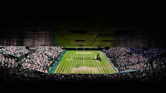 A general view of Centre Court shows  Nick Kyrgios returning the ball to Novak Djokovic during their men’s singles final tennis match on the fourteenth day of the 2022 Wimbledon Championships at The All England Tennis Club in Wimbledon, southwest London, on July 10, 2022