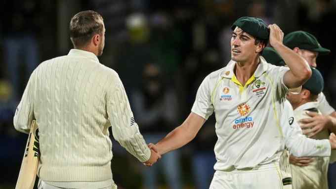 Pat Cummins of Australia shakes hands with Ollie Robinson (L) of England after Australia won the Fifth Test and the Ashes series 4-0 between Australia and England at Blundstone Arena on January 16, 2022 in Hobart, Australia