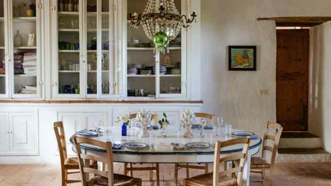 a table setting for six people in the kitchen of Villa Arniano, the Tuscan home of the interior designer Camilla Guinness
