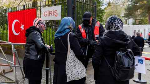 Turkish women queue outside the Turkish consulate