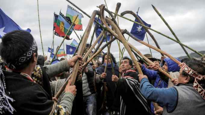 Members of the local Mapuche Indian communities hit their ‘Chuecas’, a curved wood stick, during a ‘Trawun’ (meeting) to discuss the conflict between the indigenous Mapuche and the Chilean government in Curacautin area, Temuco, Chile August 9, 2020