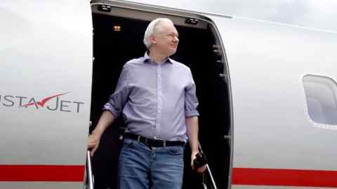 Julian Assange disembarking from an airplane