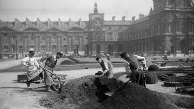 A group of gardeners from the 1930s digging a large hole