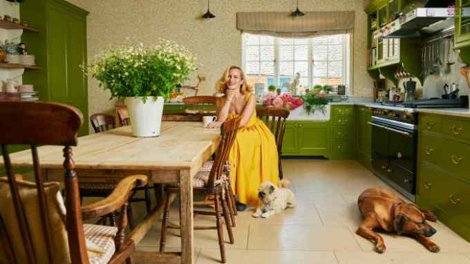 Charlotte Dellal in her kitchen with her pug-zus Boo and Sumo and her Rhodesian ridgeback Rickson