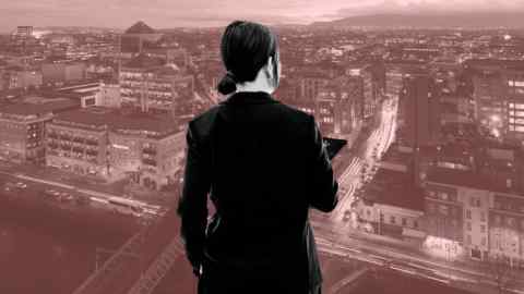Woman in business suit with her back to the camera imposed on an image of a view of the Samuel Beckett Bridge