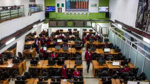 Employees work on the trading floor at the Nigerian Stock Exchange in Lagos, Nigeria