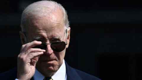 Close up Joe Biden’s face as he reaches up to put on his dark glasses