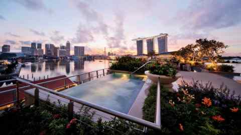 The rooftop pool of The Fullerton Bay Hotel, with the three towers of Marina Bay Sands in the background