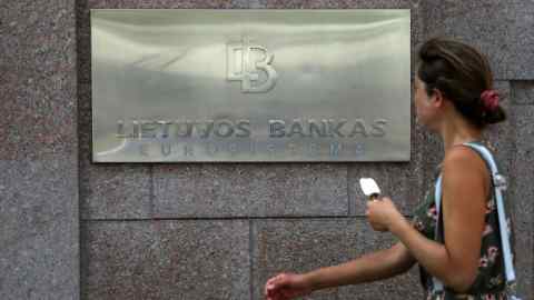 A pedestrian passes Lithuania’s central bank, also known as Lietuvos Bankas, in Vilnius
