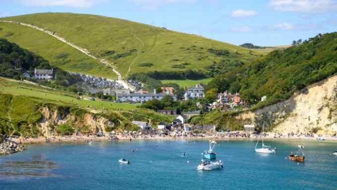 Lulworth Cove, West Lulworth, Dorset, UK, bustling with visitors and tourists