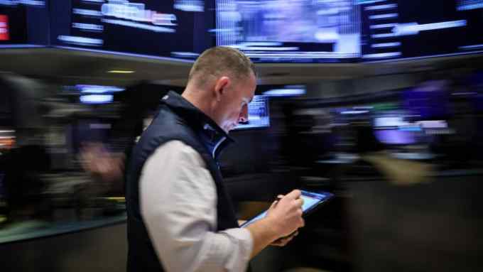 A trader works on the floor at the New York Stock Exchange